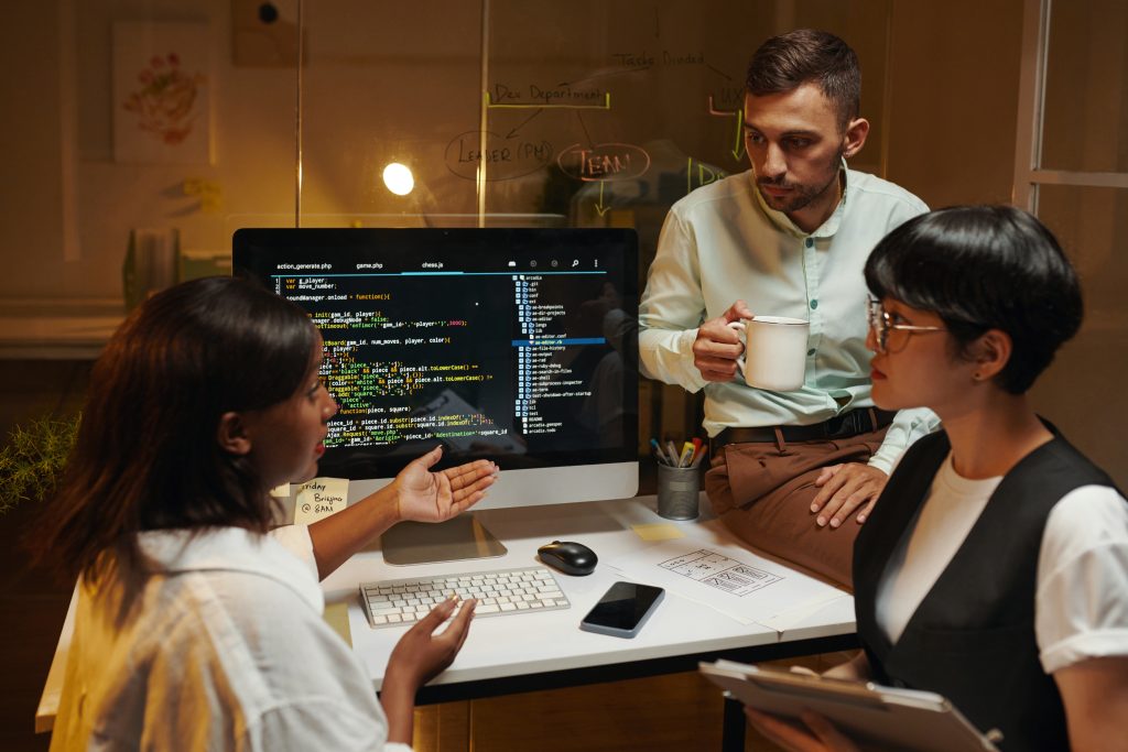 Software Development Team Leader Talking to Coworkers